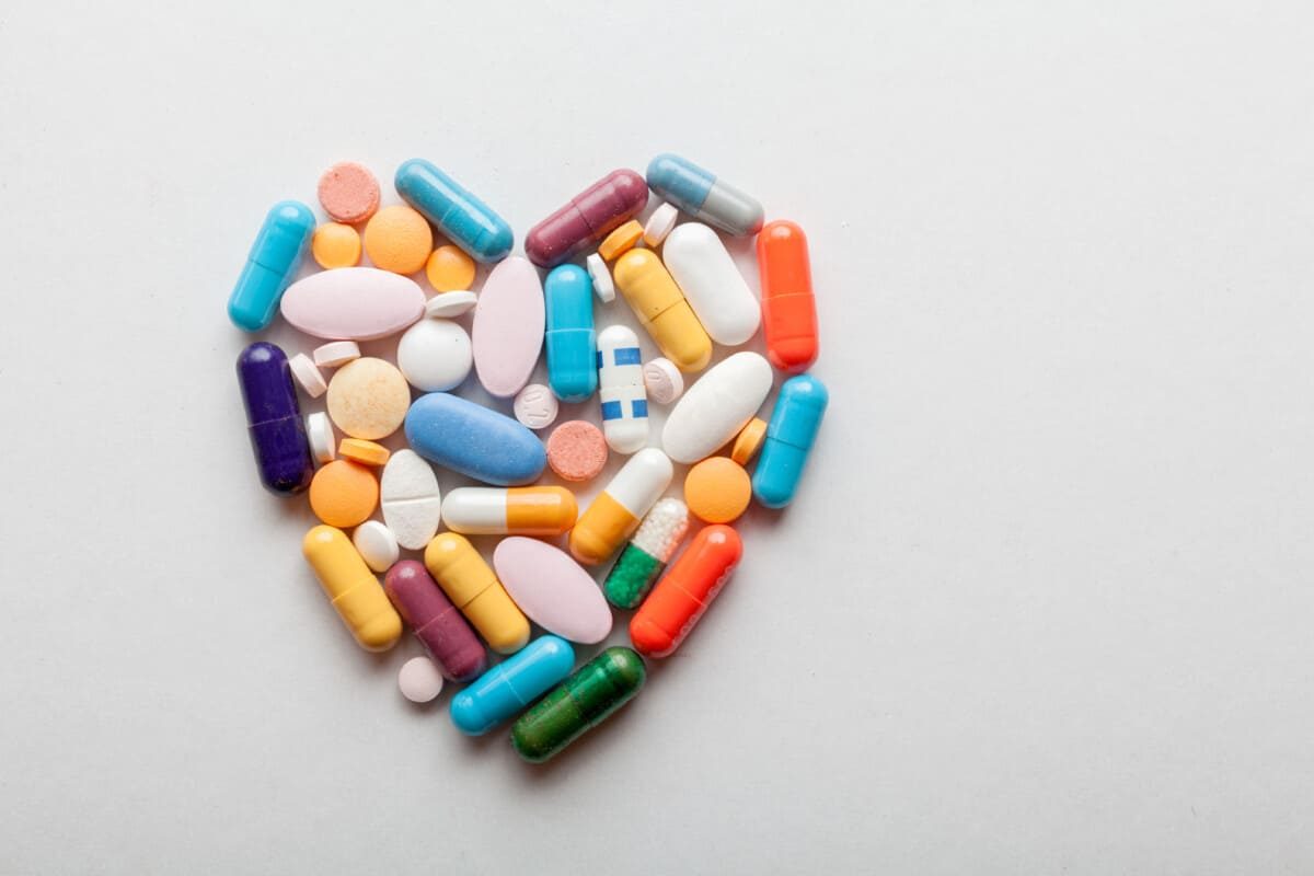 Colorful tablets and pills arranged in heart shape