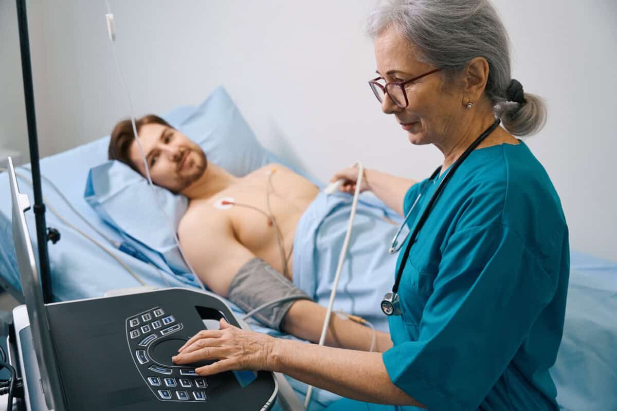 Elderly cardiologist examines the work of a young patients heart, the female doctor uses modern equipment