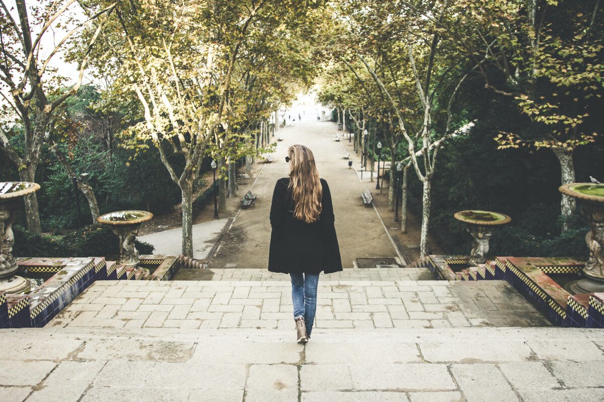 A woman walking down stairs in Barcelona, Spain